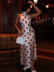 Model wearing a white polka dot halter neck maxi dress