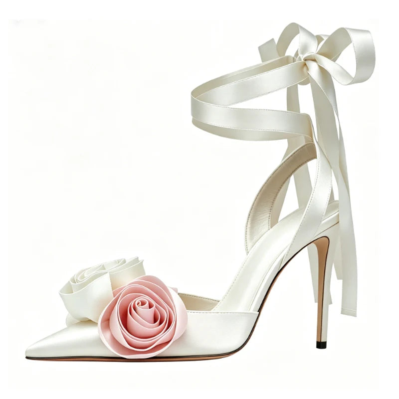 White satin stiletto sandals with pink rose embellishments and ankle tie.