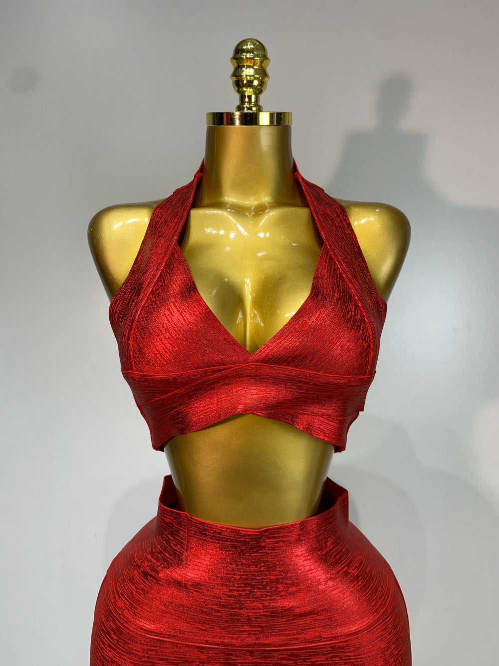 Close-up of the metallic knit halter neck crop top.