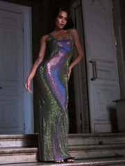 Woman wearing a green sequin dress standing in a doorway.
