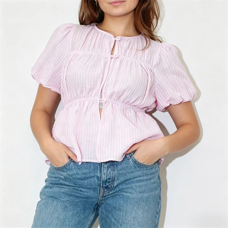 Front view of a pink striped puff sleeve button-front peplum top