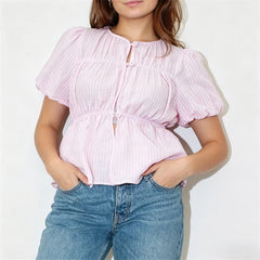 Front view of a pink striped puff sleeve button-front peplum top