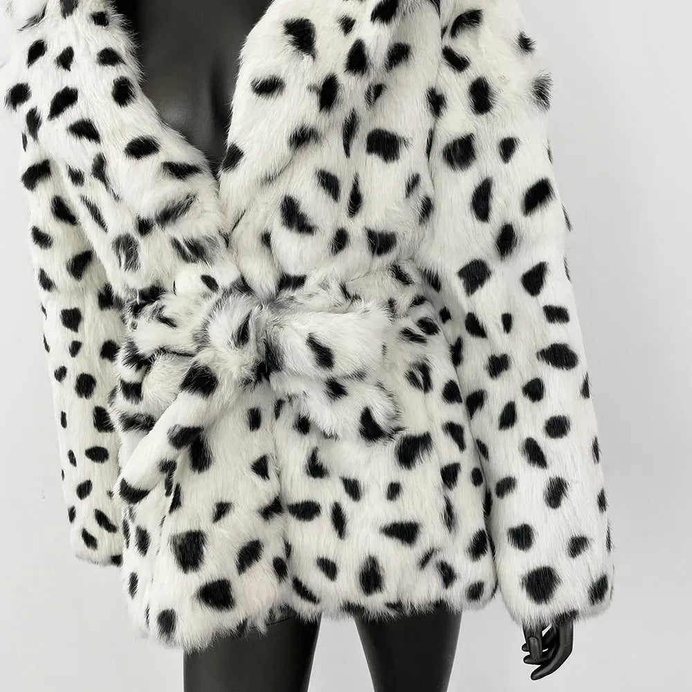 White fur coat with black spots on a plain background