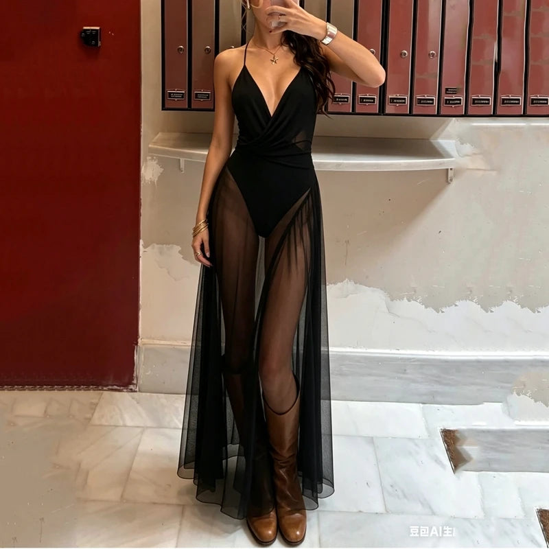 Deep V-neck sheer mesh overlay maxi dress in an urban hallway.