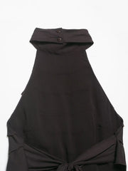 Black halter top with a button detail on a white background