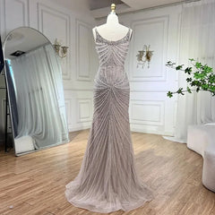   Mannequin displaying the pearl-beaded mermaid evening gown, showcasing its flattering silhouette and flowing train. Golden Atelier 3