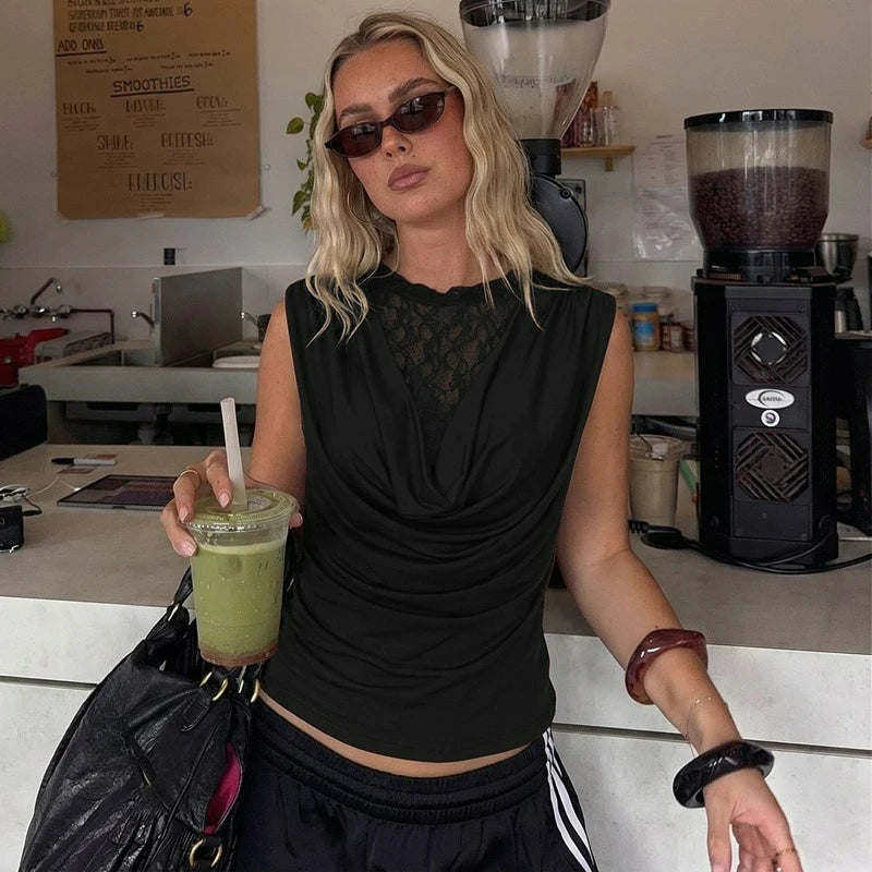 Woman holding a green smoothie in a cafe