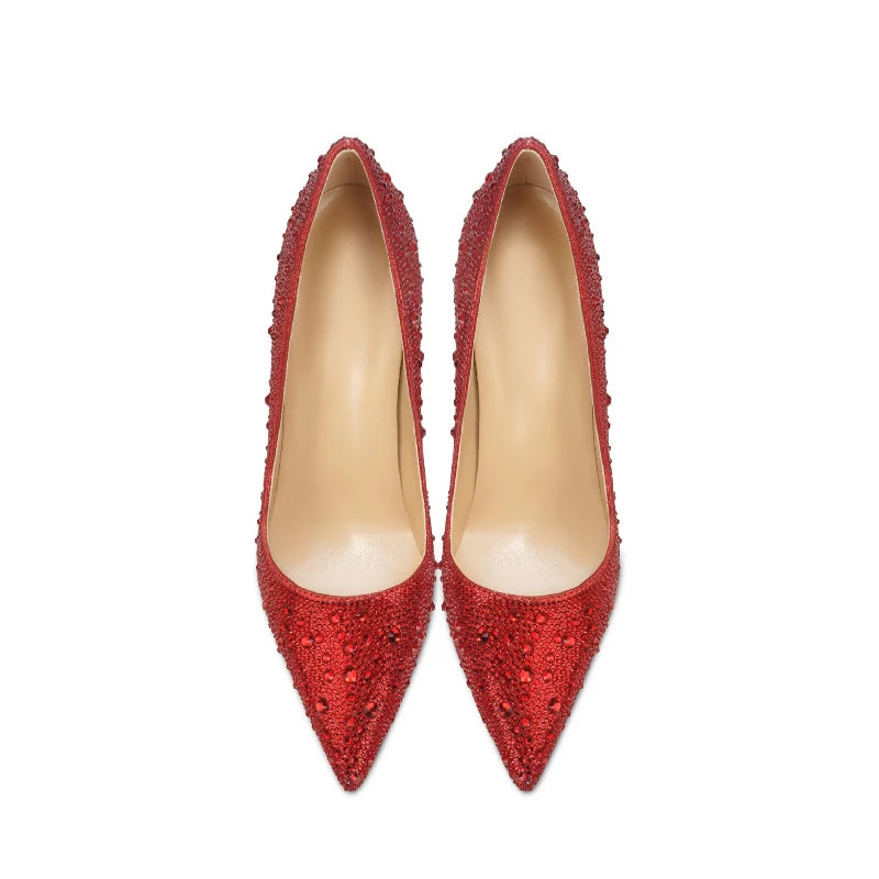 Pair of red high-heeled shoes with embellishments