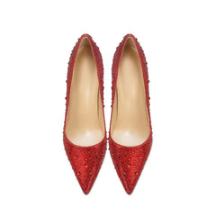 Pair of red high-heeled shoes with embellishments