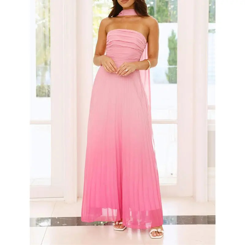 Woman in a pink gradient strapless maxi dress with scarf