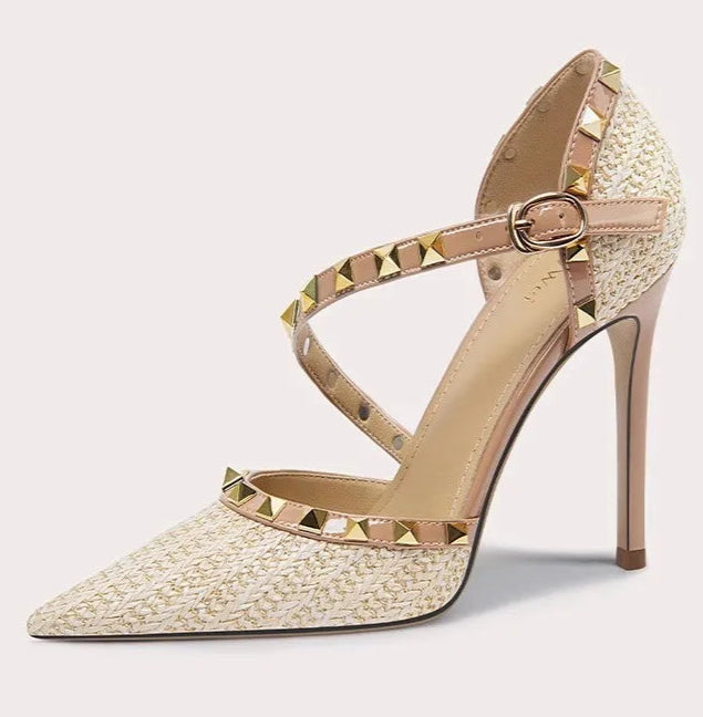 High-heeled shoe with studded details on a light gray background