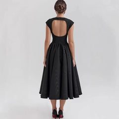 Black dress with open back on a white background