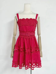 Red lace dress on a mannequin against a white background
