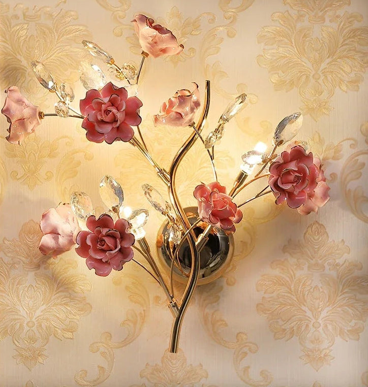 Decorative wall light fixture with floral design on a patterned wall.