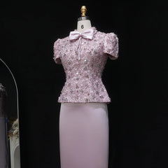Pink sequin top with a bow on a mannequin against a black background