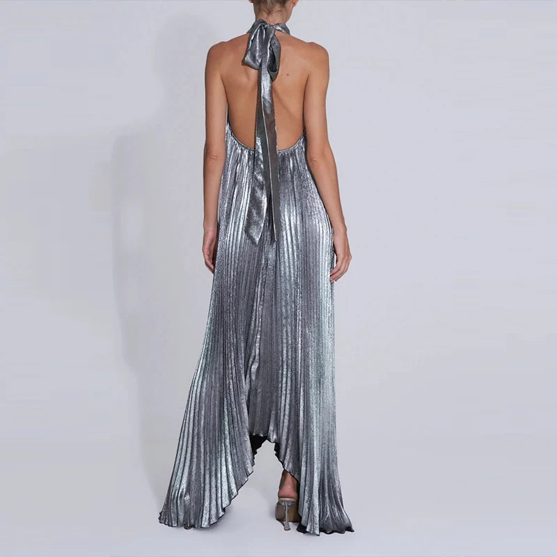 Silver metallic halter neck dress with a long train on a white background
