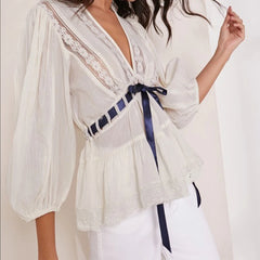 White puff sleeve lace trim peplum top shown from side