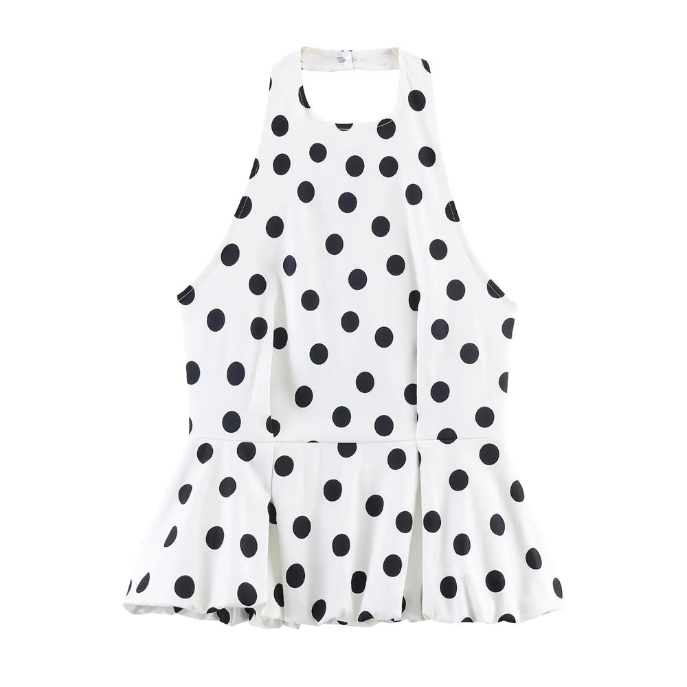 White dress with black polka dot pattern on a white background