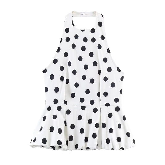 White dress with black polka dot pattern on a white background