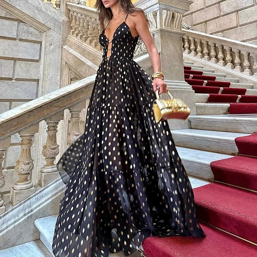 Black and gold polka dot maxi Skirt worn by a woman on stairs
