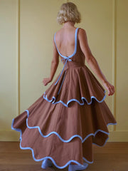Back view of brown ruffled hem maxi dress with blue trim