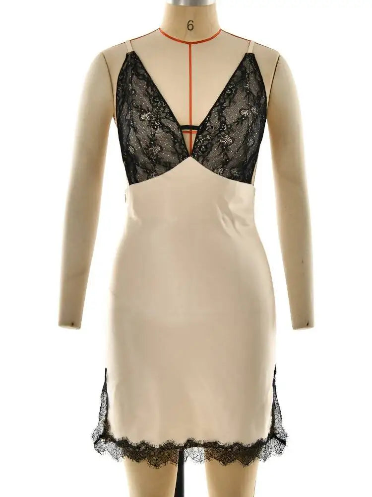 Beige dress with black lace detailing on a mannequin against a white background