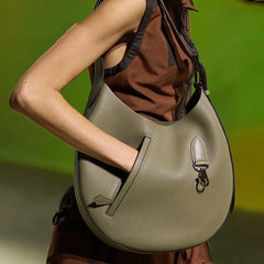 A woman stylishly carrying the crossbody bag, showcasing its versatility and size.