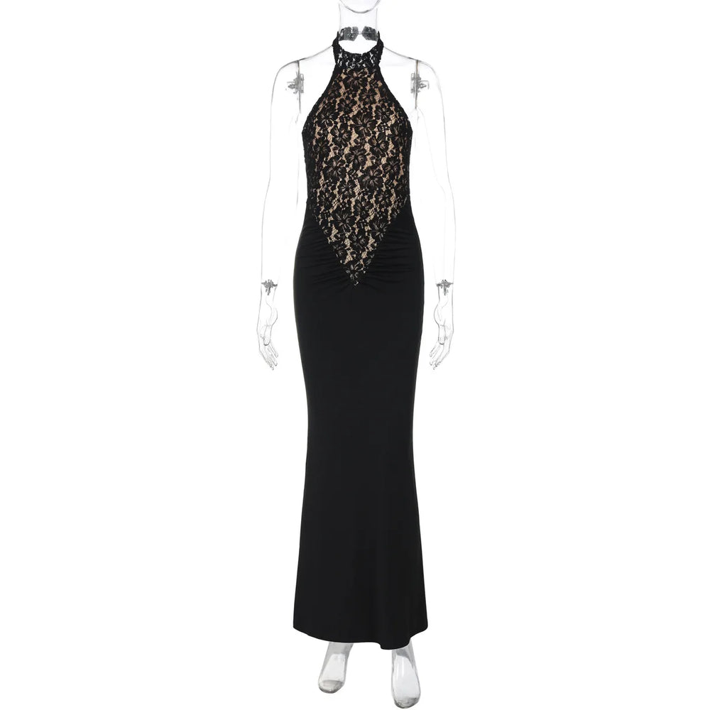 Black evening gown with gold embellishments on a mannequin against a white background