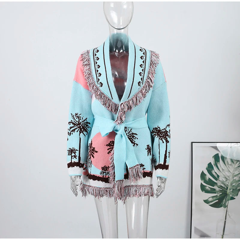 Mannequin wearing a light blue cardigan with palm tree and sun design on a white background