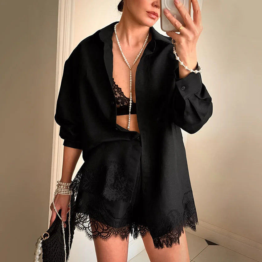 Person wearing a black outfit with lace details in a neutral setting