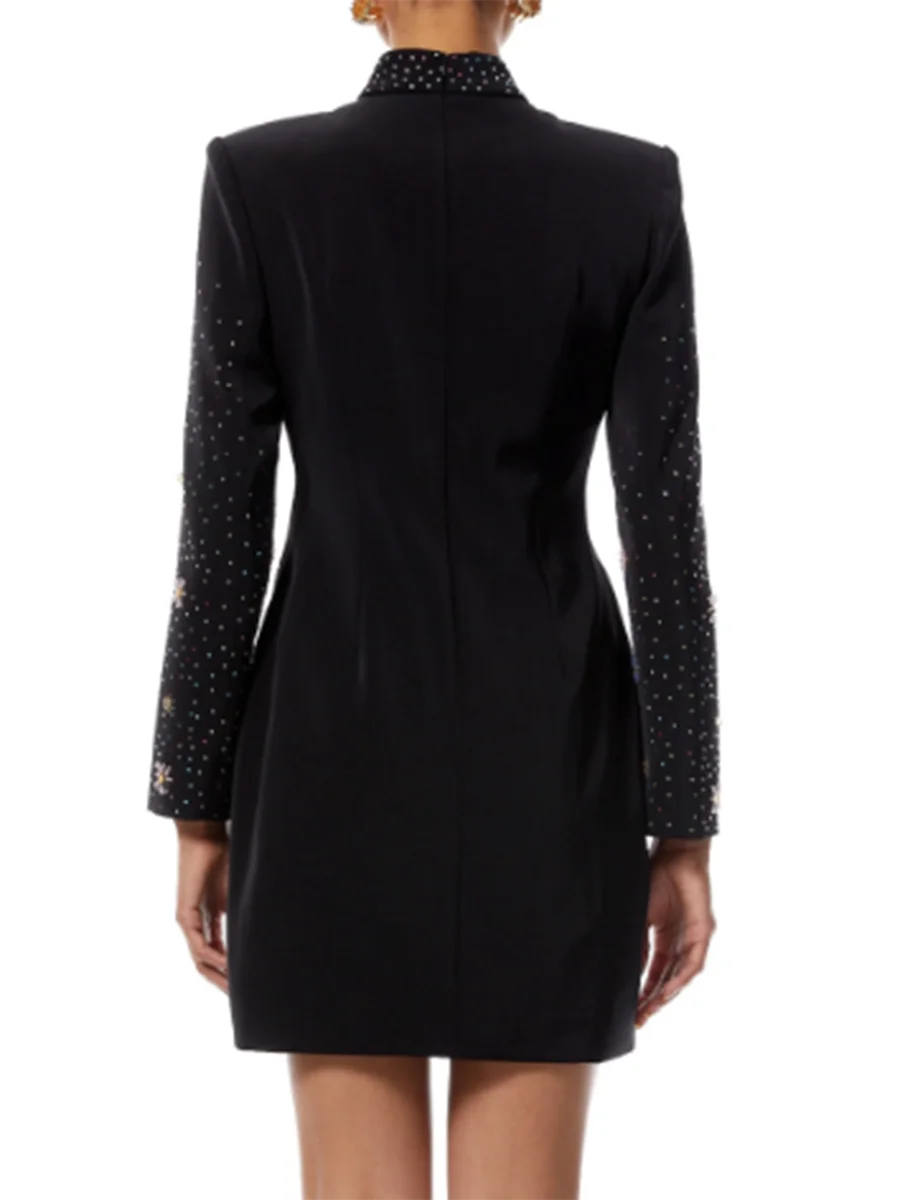 Black dress with embellished sleeves on a white background