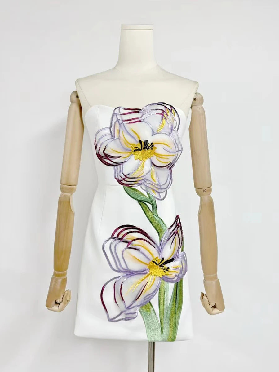 Dress with floral design on a mannequin against a white background