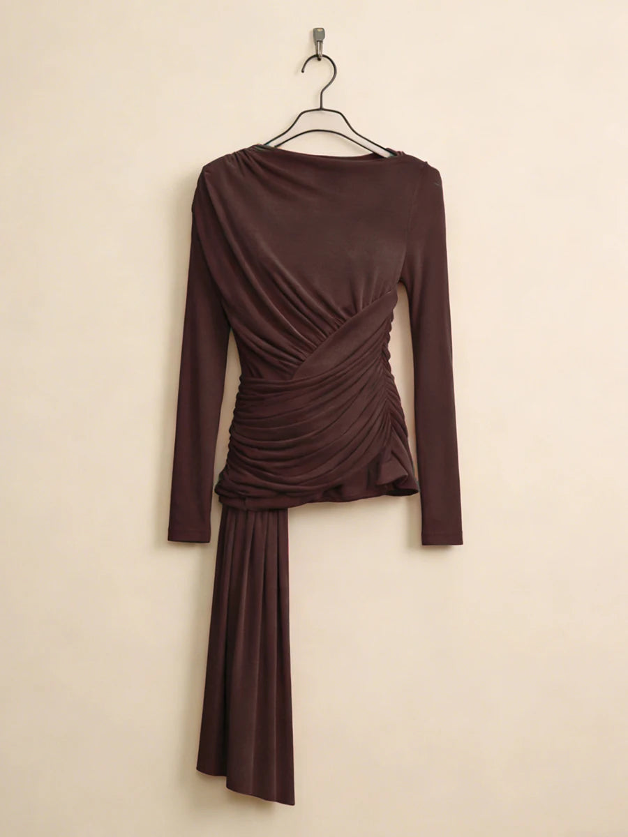 Brown dress with long sleeves and a draped design on a beige background