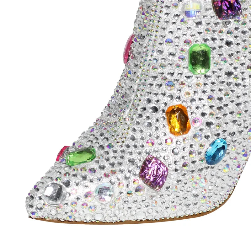 Close-up of rhinestone and gemstone embellishments on a pointed toe boot