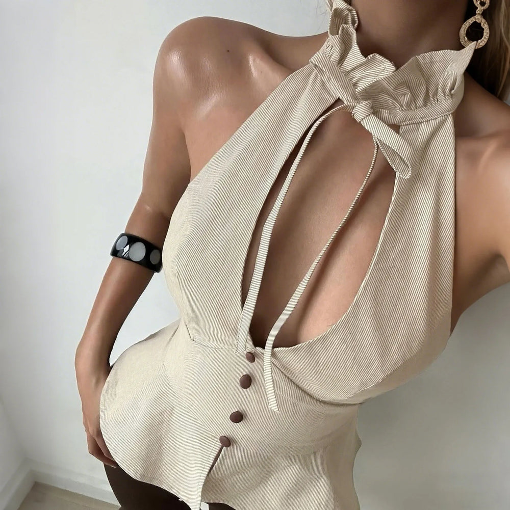 Beige halter top with button details on a plain background