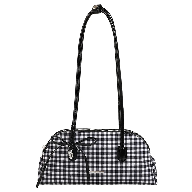 Black and white gingham pattern shoulder bag with black patent handles and a black bow detail.