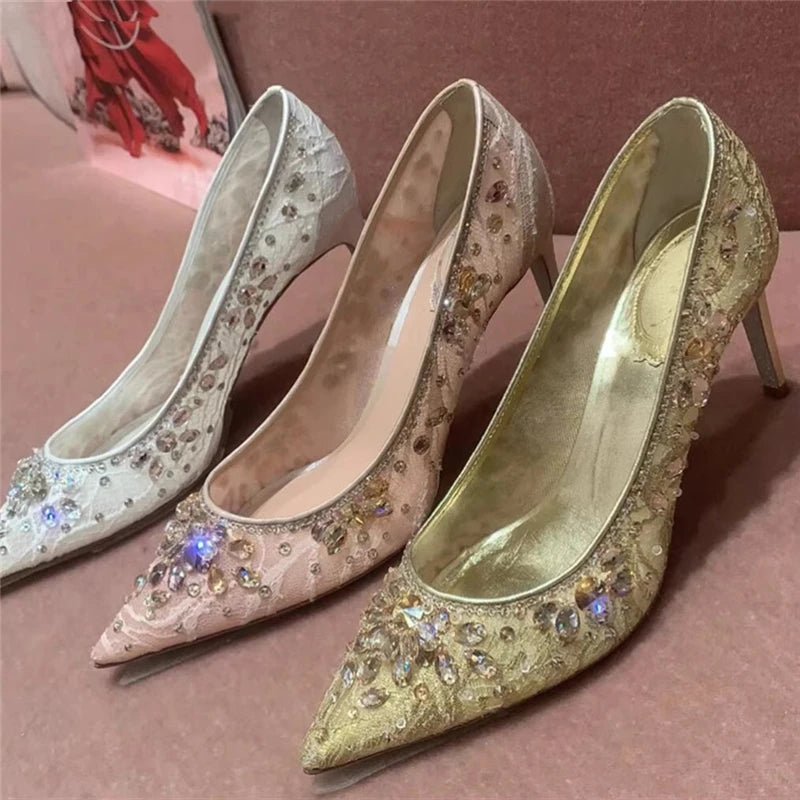 Three high-heeled shoes with sparkling embellishments on a pink surface.
