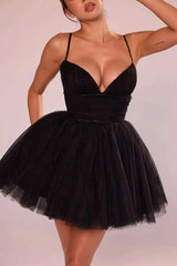 Black dress with a sheer overlay on a plain background