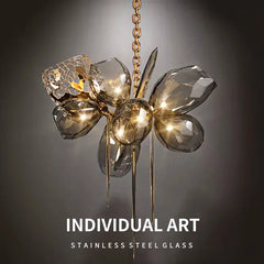 Decorative chandelier with glass and metal design on a dark background, labeled 'INDIVIDUAL ART'.