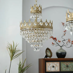 Gold chandelier with crystal accents hanging in a room with decor elements.