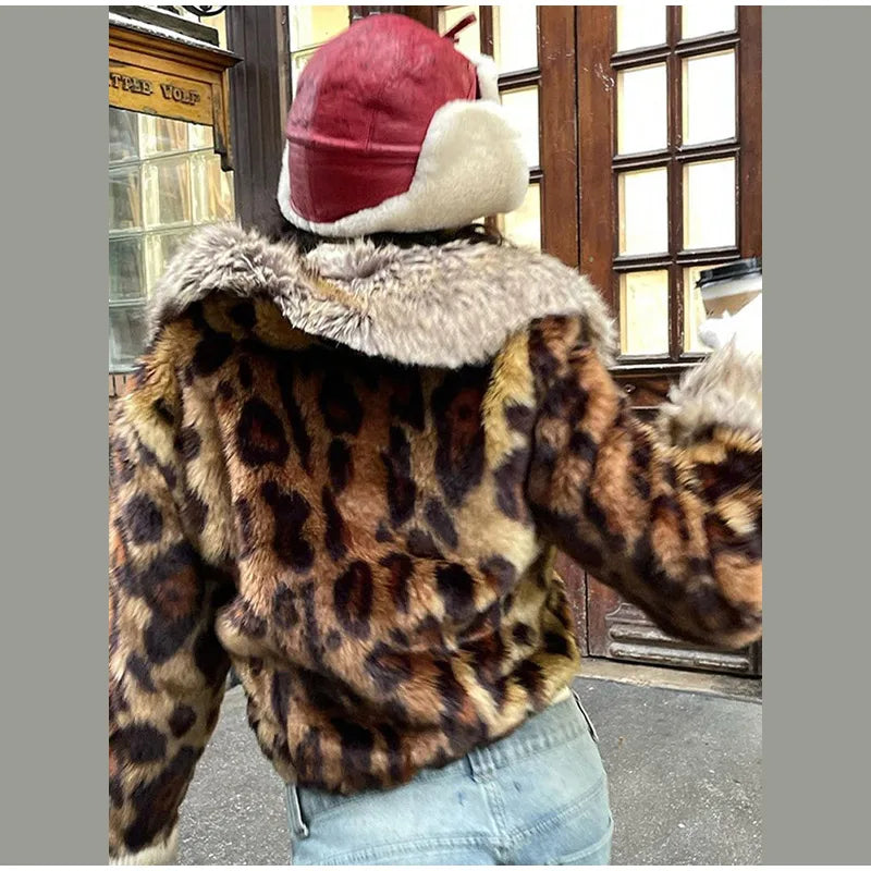Person wearing a leopard print jacket with fur lining and a red and white cap.