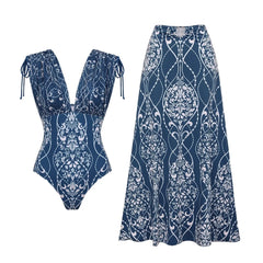 Blue and white architectural print two-piece swimwear set laid flat, including a plunge neckline top and maxi skirt.