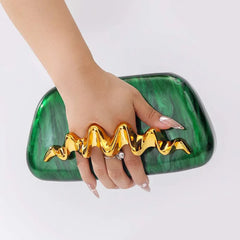 Sculptural wave handle clutch bag with green acrylic exterior