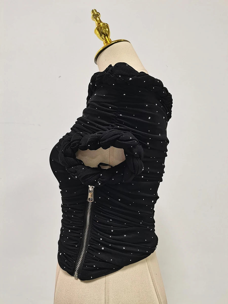 Black textured dress on a mannequin with a plain background