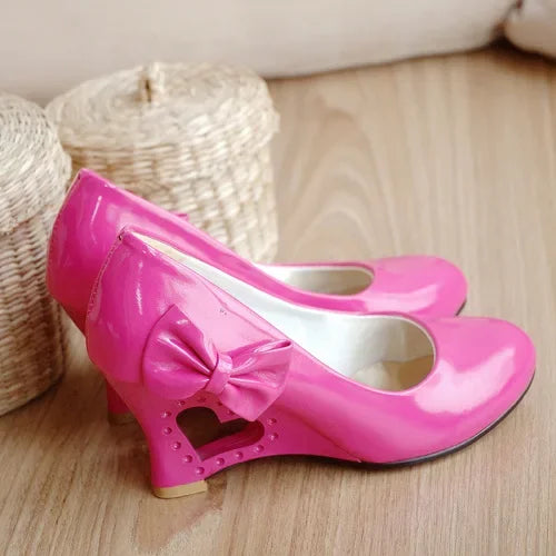 Side view of patent leather high heel pumps