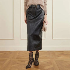 Model wearing black floral mesh ankle boots with a leather skirt