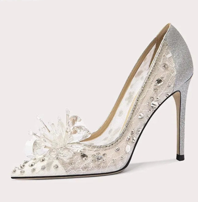 Silver high-heeled shoe with floral design on a white background
