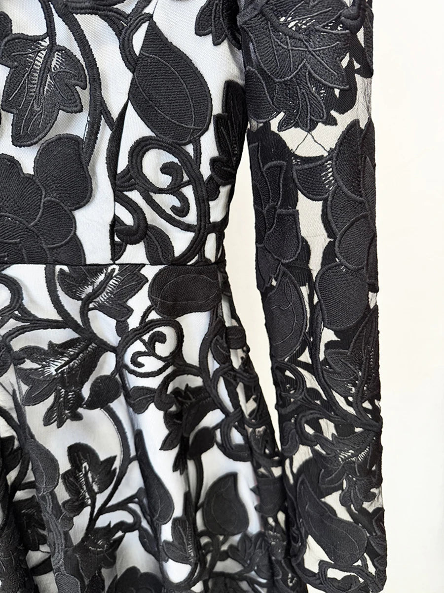 Close-up of a black floral lace fabric on a white background