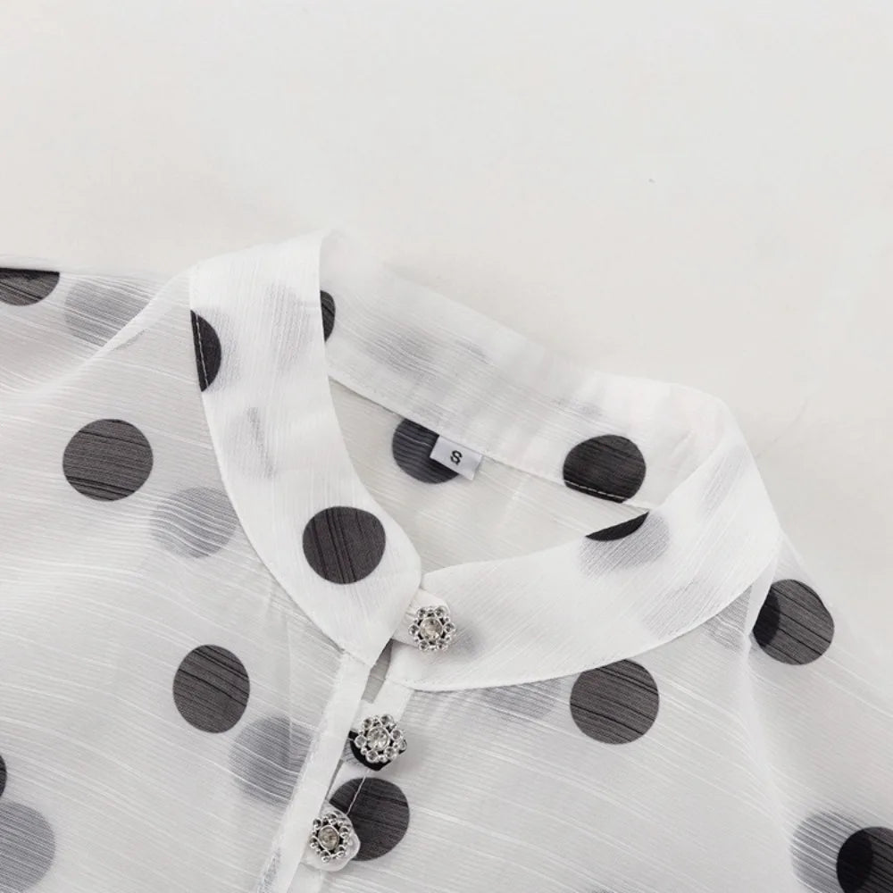 White polka dot dress with black dots on a white background