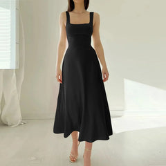 Black dress worn by a model in a minimalistic setting